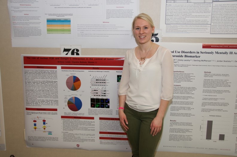 Brittany Ledall stands by her poster at the Inland Northwest Research Symposium at WSU Spokane on April 1, 2016.