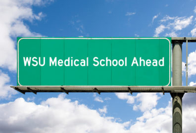 This is a graphic that portrays a green highway sign saying "WSU Medical School Ahead".