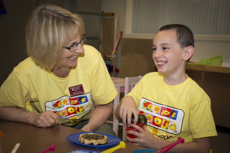 Speech and Hearing Sciences Associate Professor Nancy Potter works with one of the children attending this summer's Camp Candoo for children with apraxia on the WSU Spokane campus.